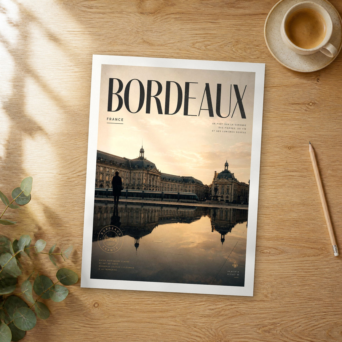 Unframed Bordeaux bold typography travel poster on a wooden table