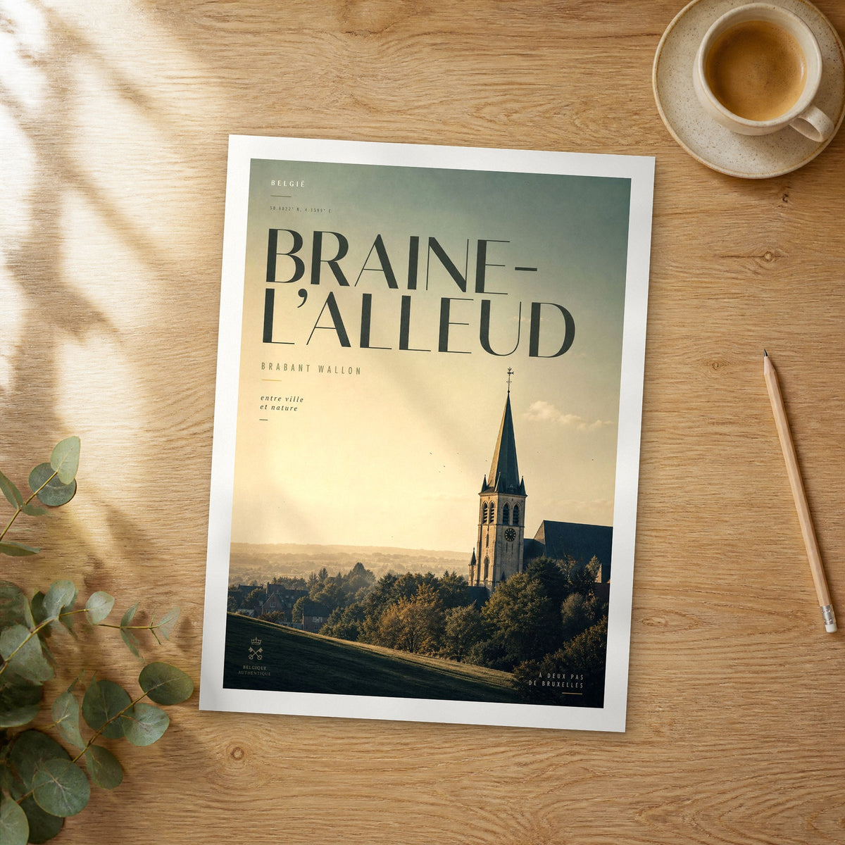 Unframed Braine-l’Alleud bold typography travel poster on a wooden table