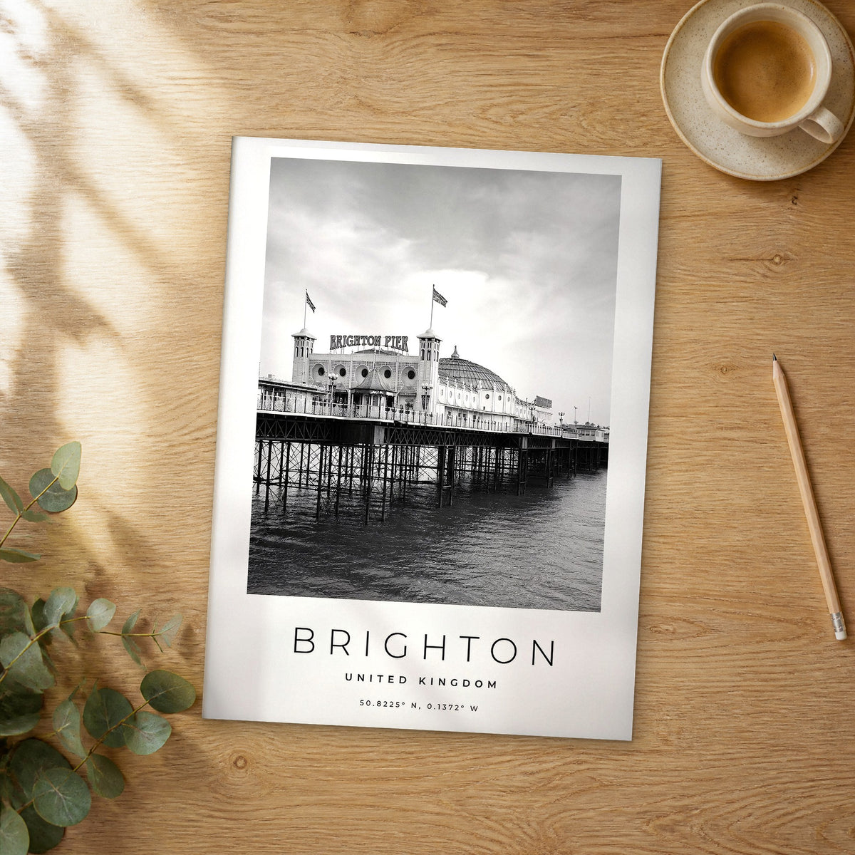 Unframed Brighton black and white travel poster on a wooden table