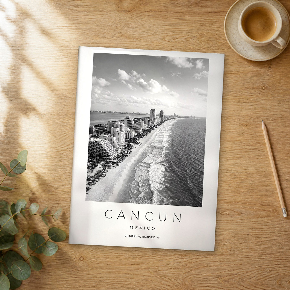 Unframed Cancun black and white travel poster on a wooden table