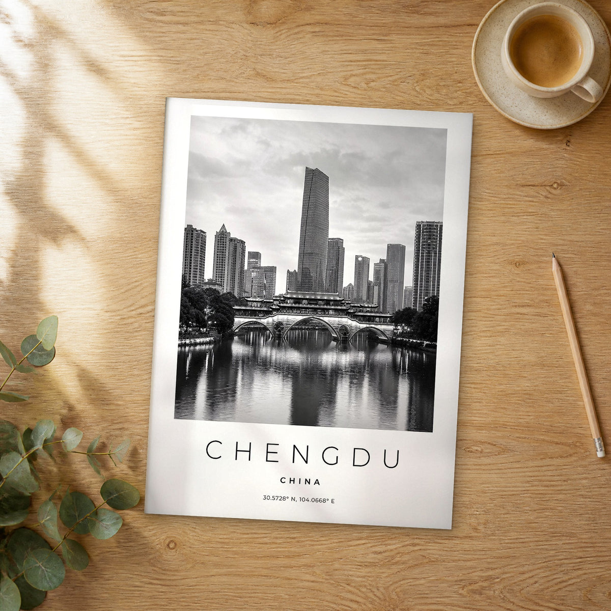 Unframed Chengdu black and white travel poster on a wooden table