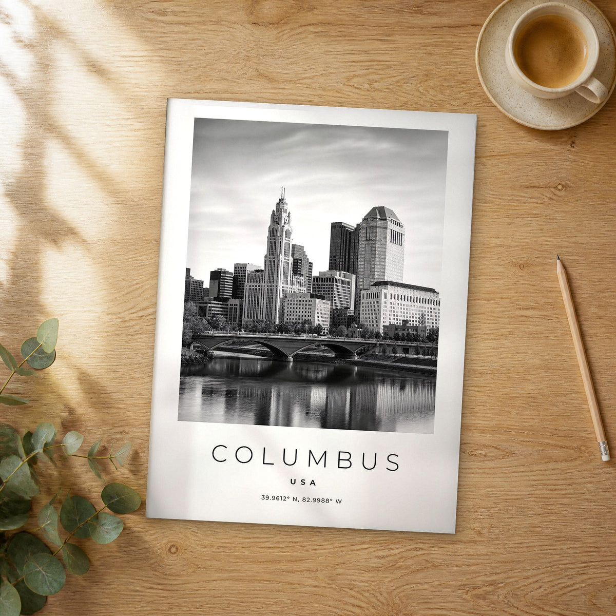 Unframed Columbus black and white travel poster on a wooden table