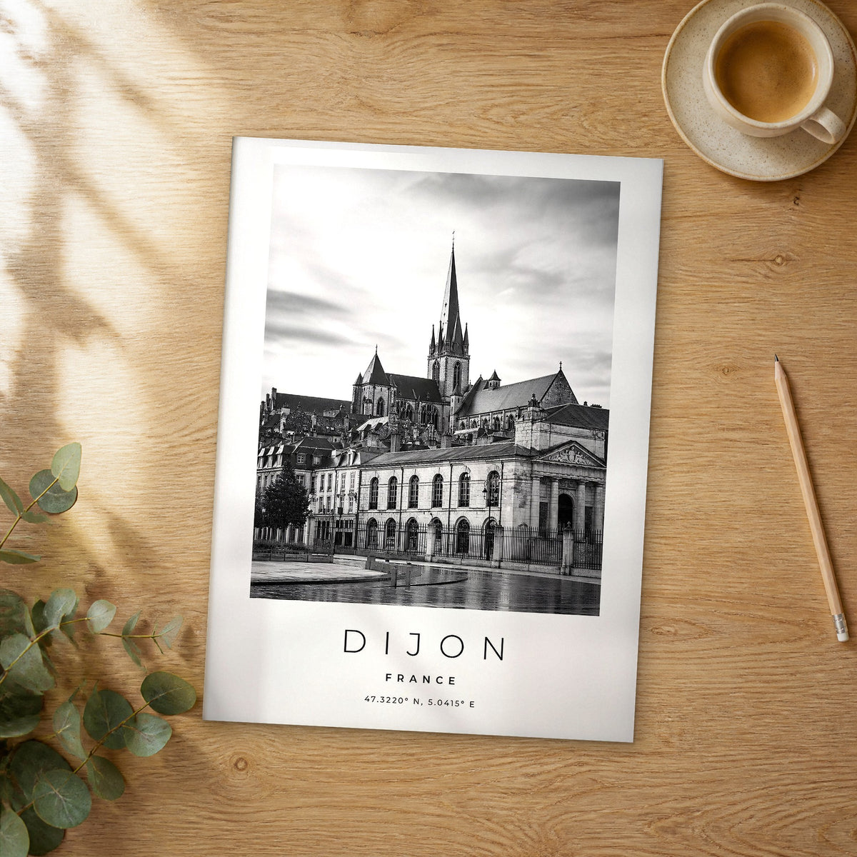 Unframed Dijon black and white travel poster on a wooden table