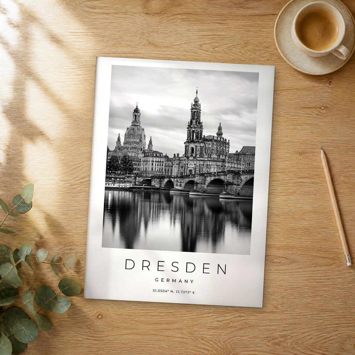 Unframed Dresden black and white travel poster on a wooden table