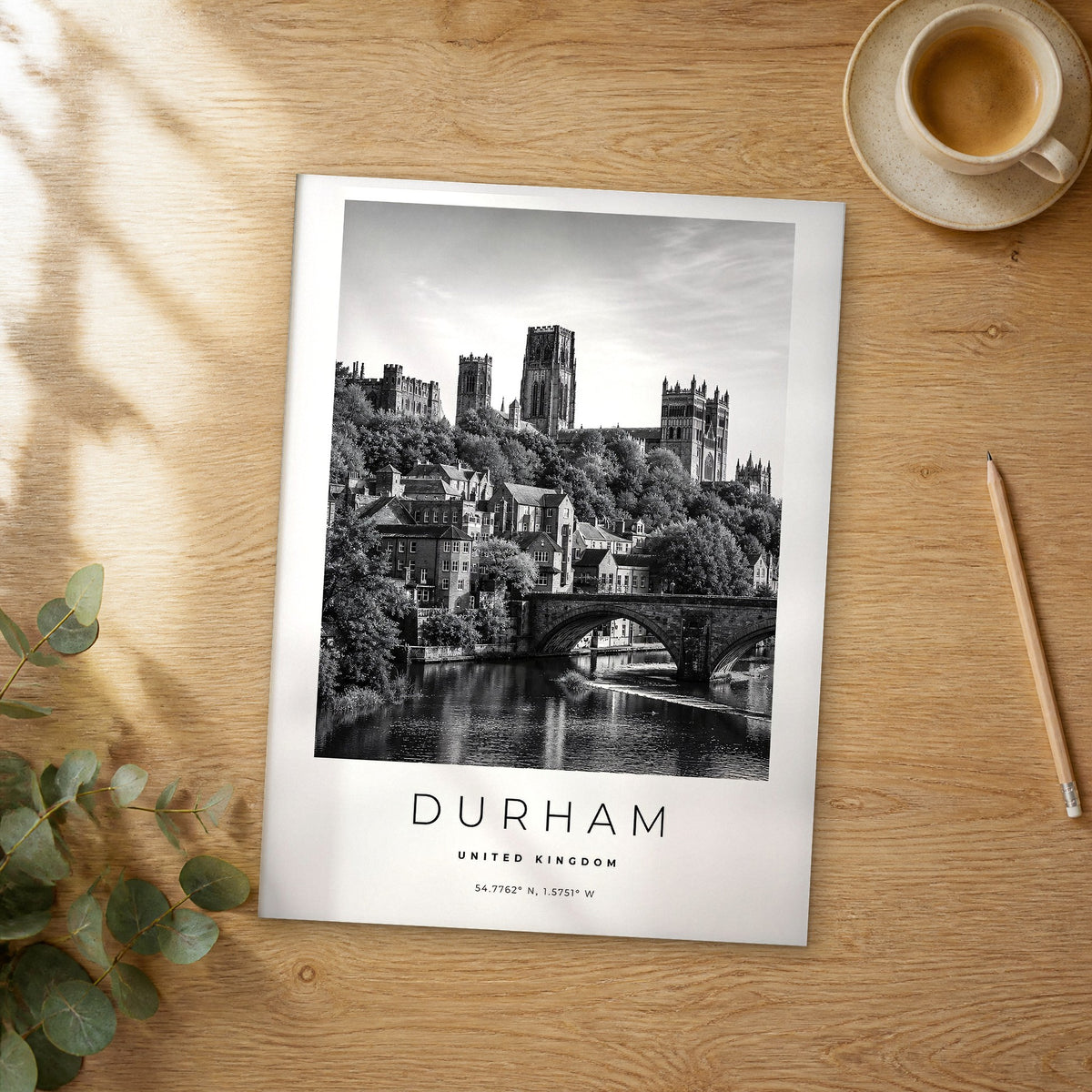 Unframed Durham black and white travel poster on a wooden table