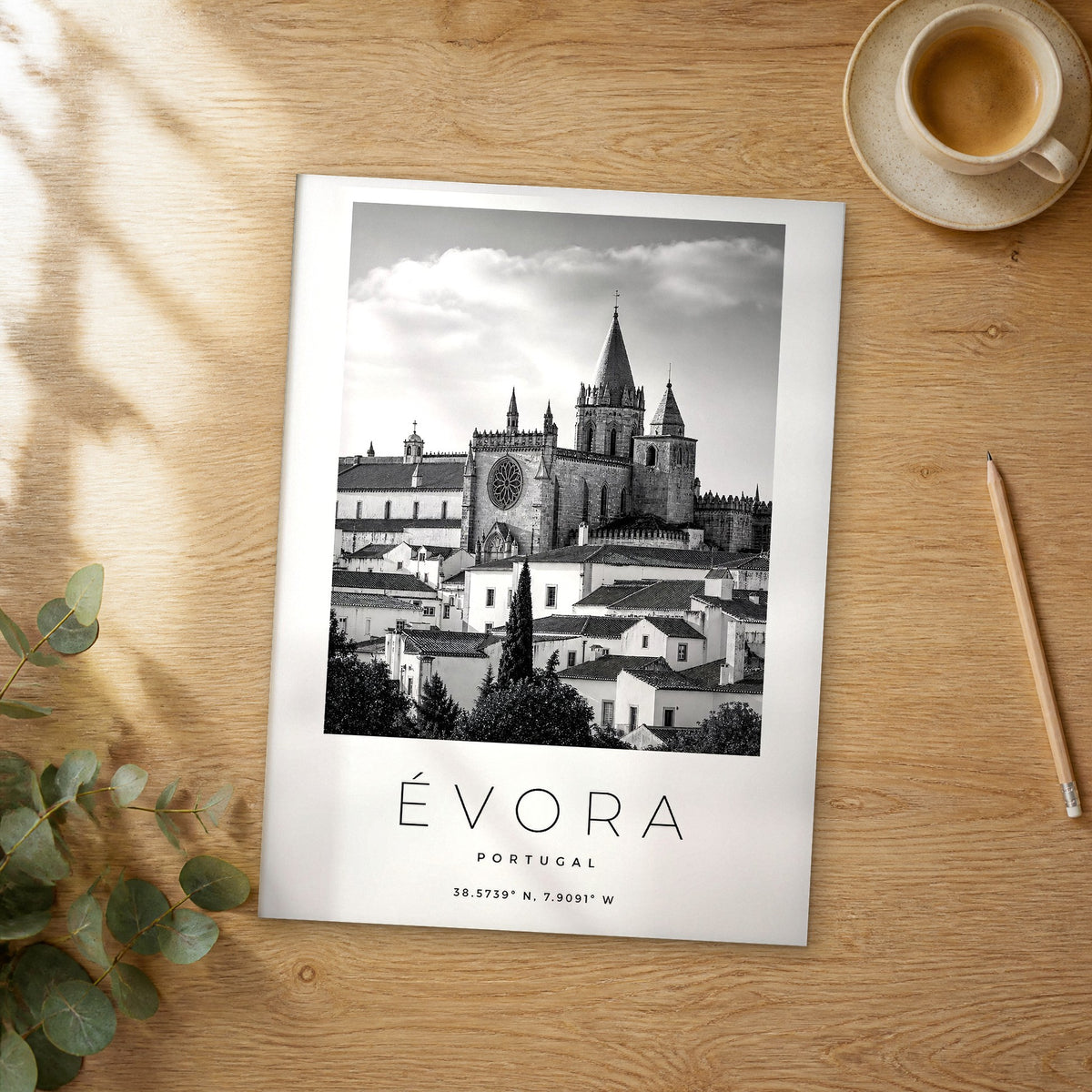 Unframed Évora black and white travel poster on a wooden table