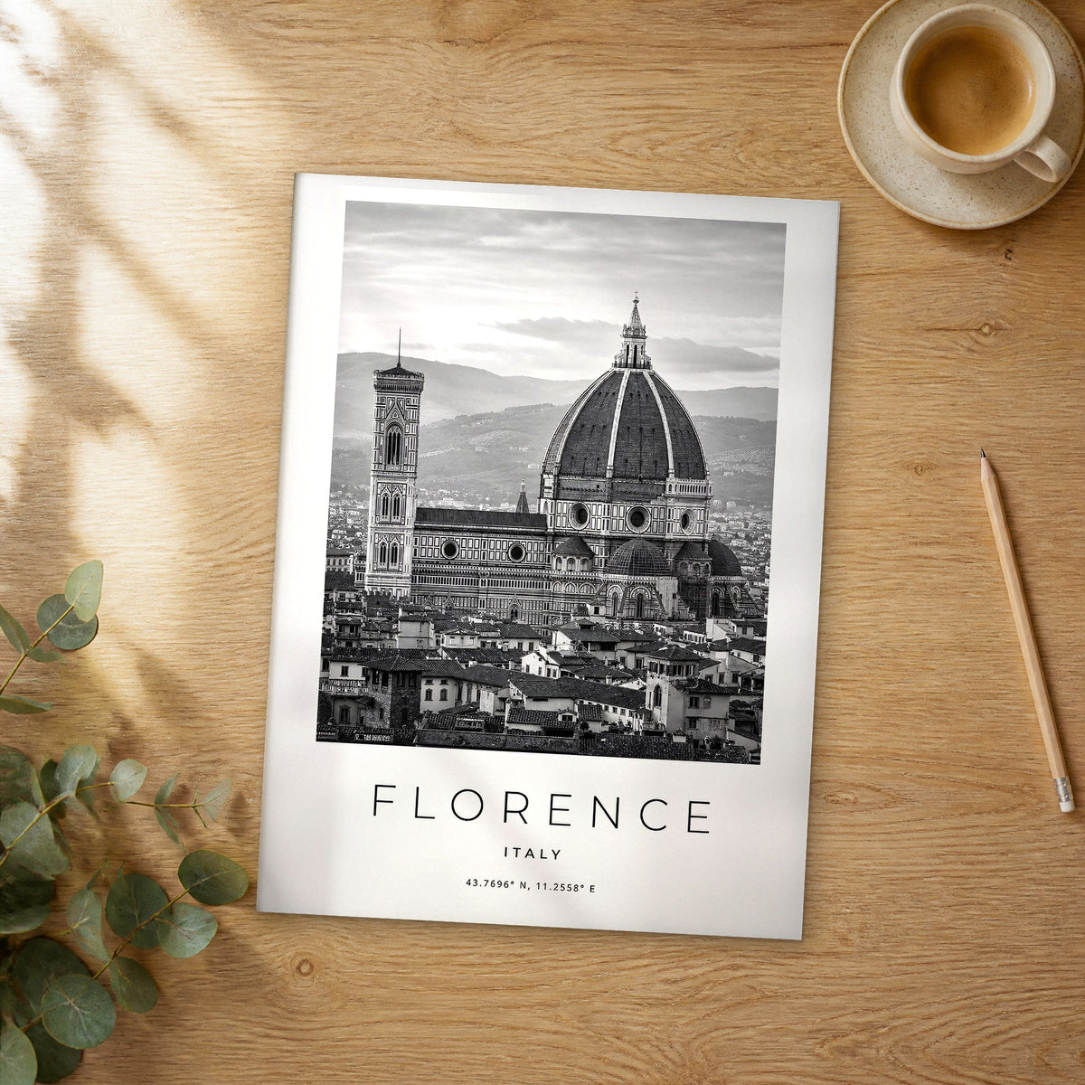 Unframed Florence black and white travel poster on a wooden table