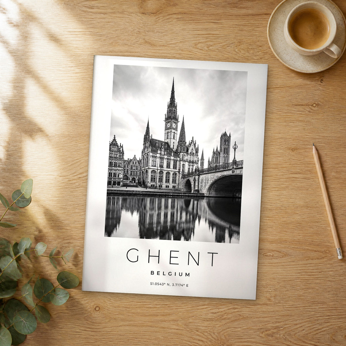 Unframed Ghent black and white travel poster on a wooden table
