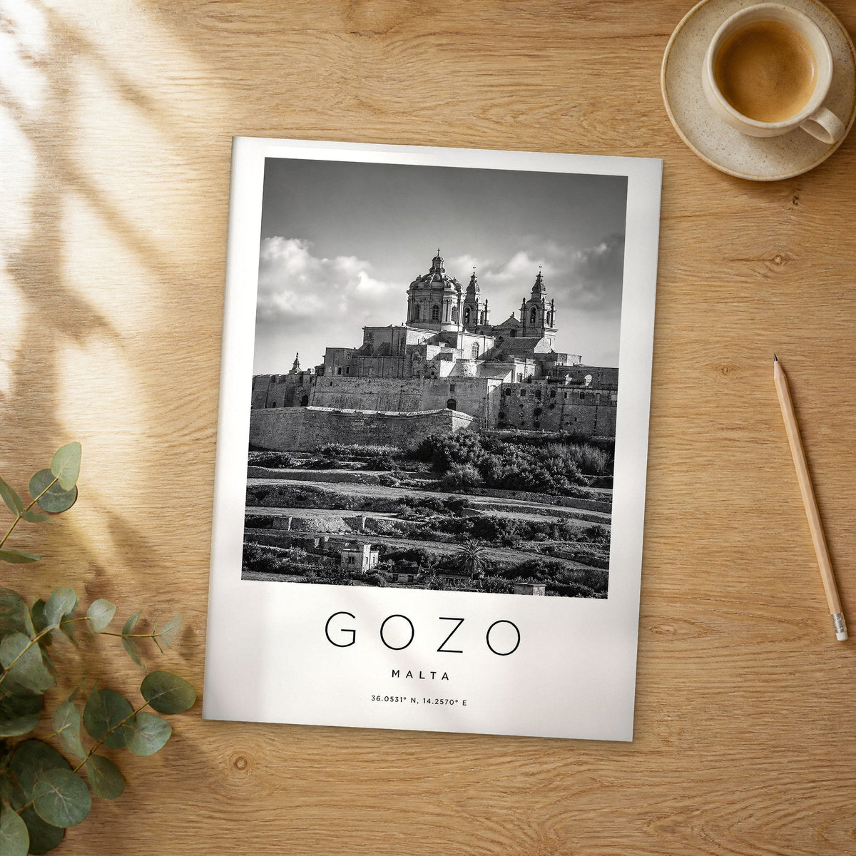 Unframed Gozo black and white travel poster on a wooden table