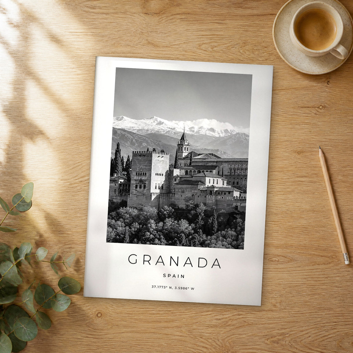 Unframed Granada black and white travel poster on a wooden table