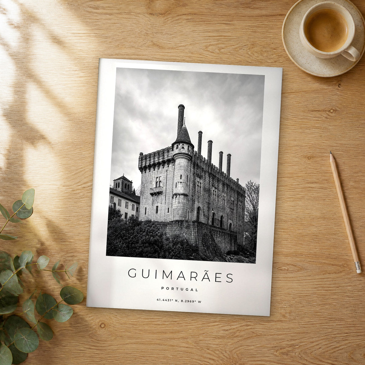 Unframed Guimarães black and white travel poster on a wooden table