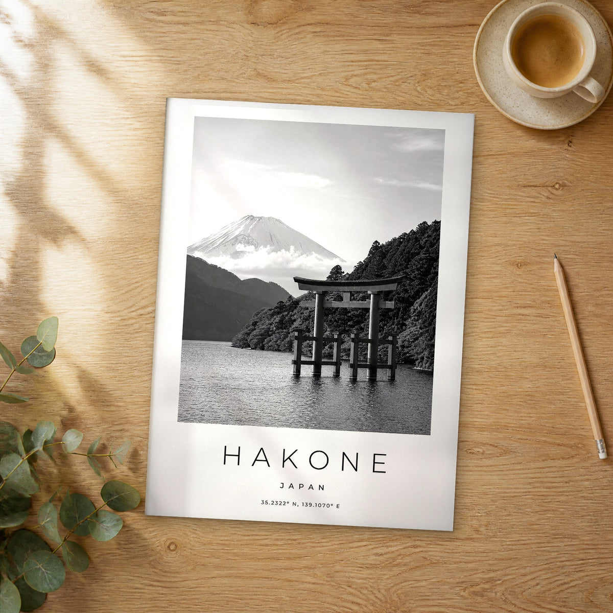 Unframed Hakone black and white travel poster on a wooden table