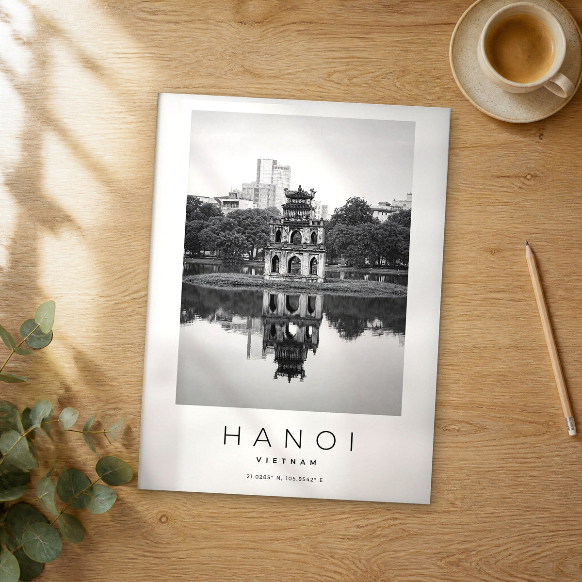 Unframed Hanoi black and white travel poster on a wooden table
