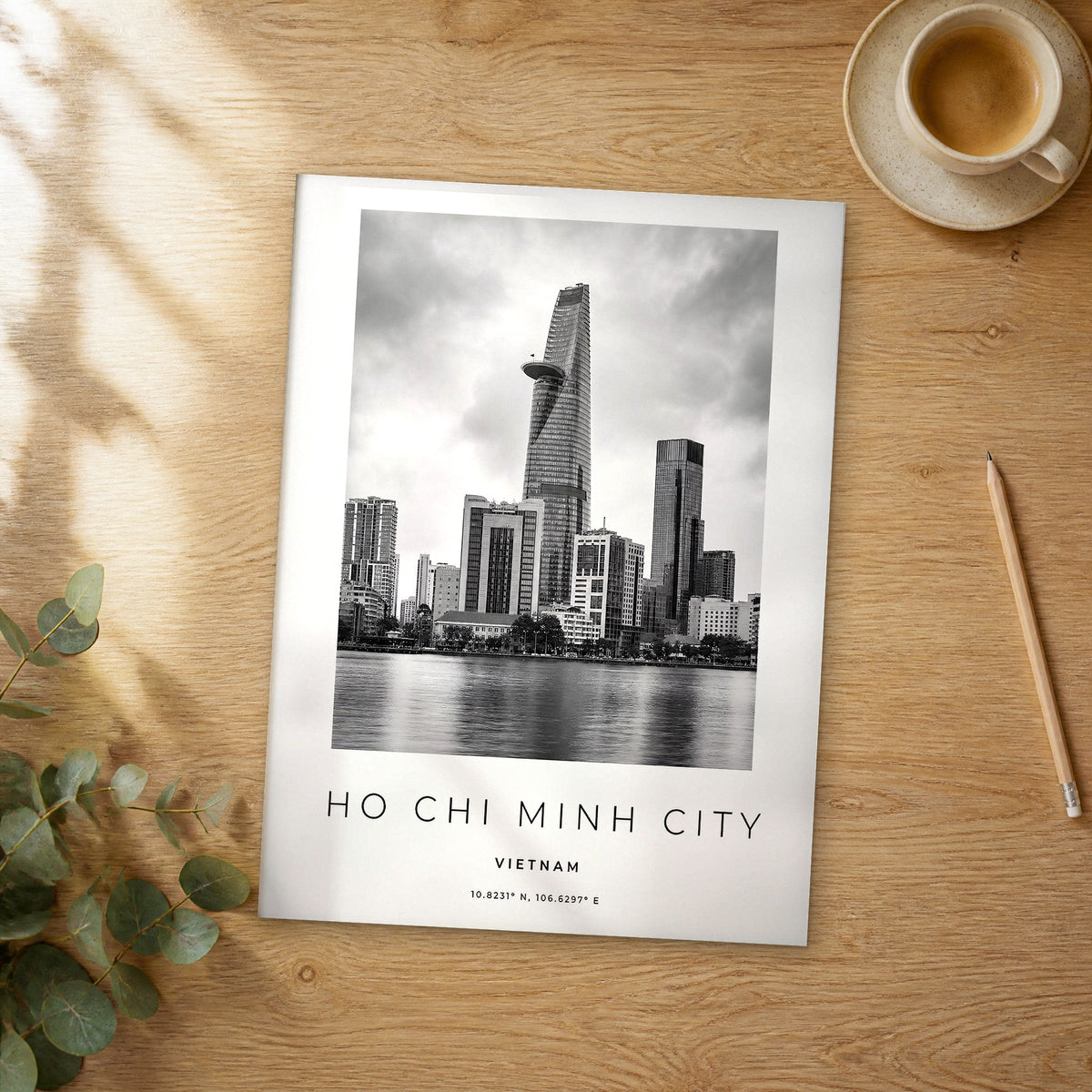 Unframed Ho Chi Minh City black and white travel poster on a wooden table