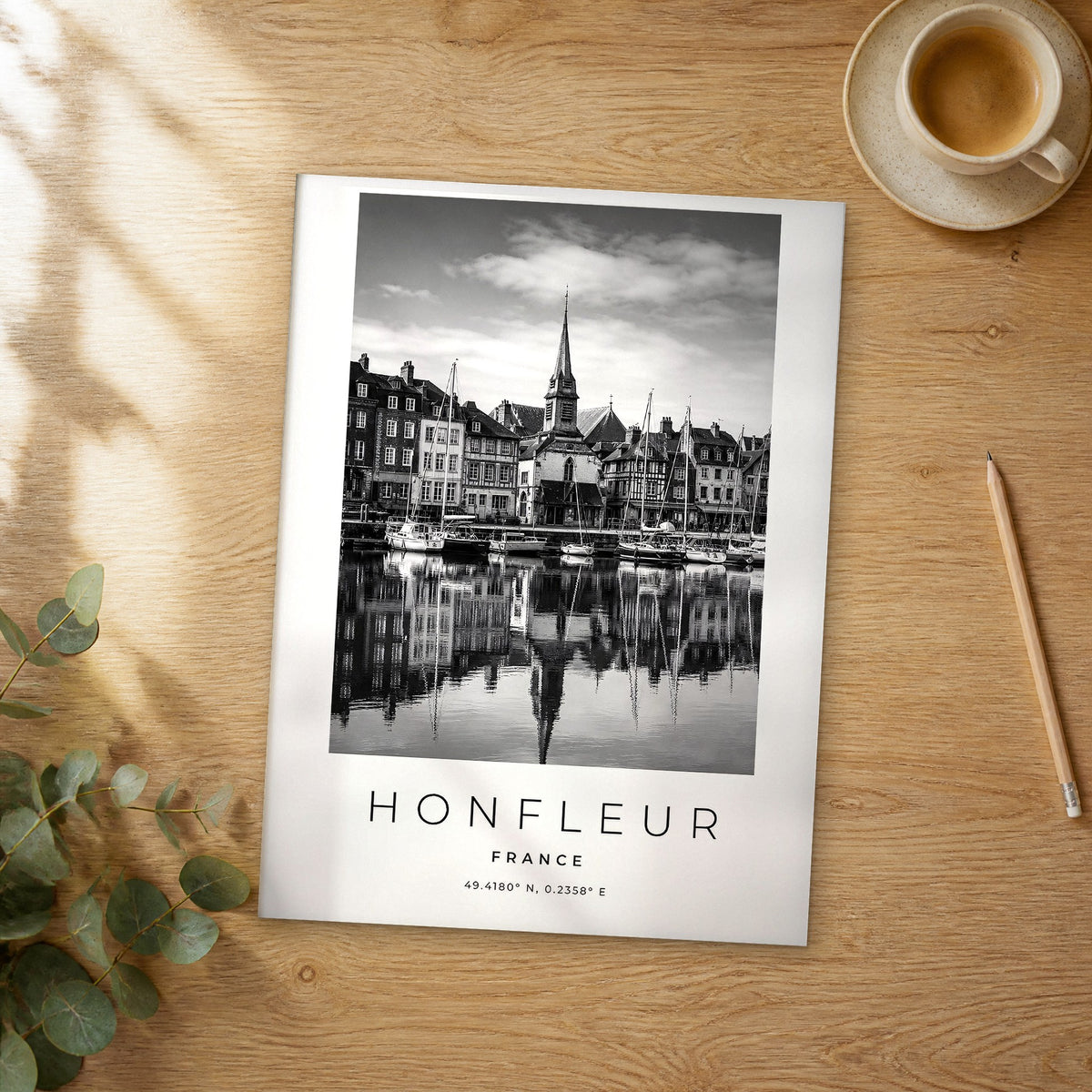 Unframed Honfleur black and white travel poster on a wooden table