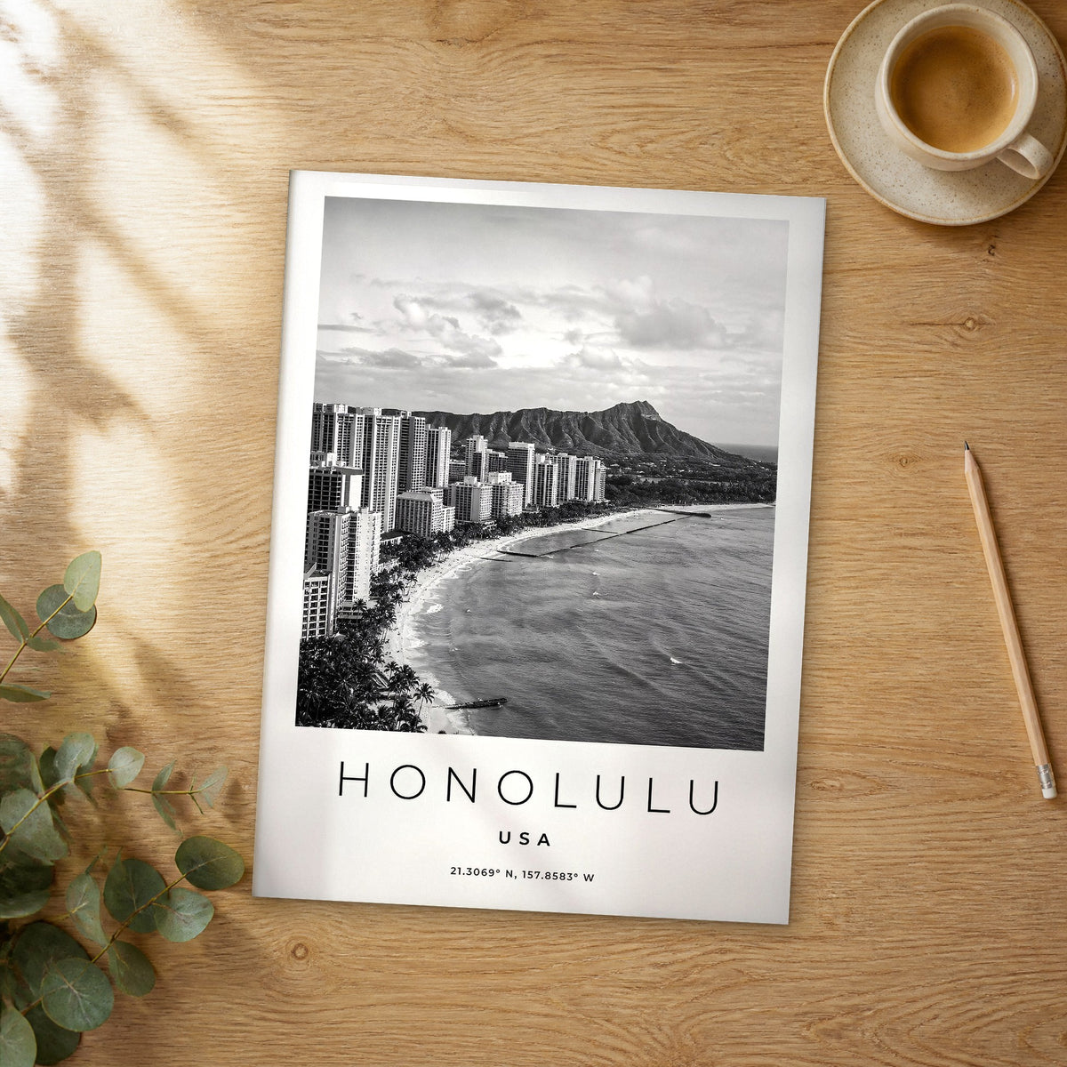 Unframed Honolulu black and white travel poster on a wooden table