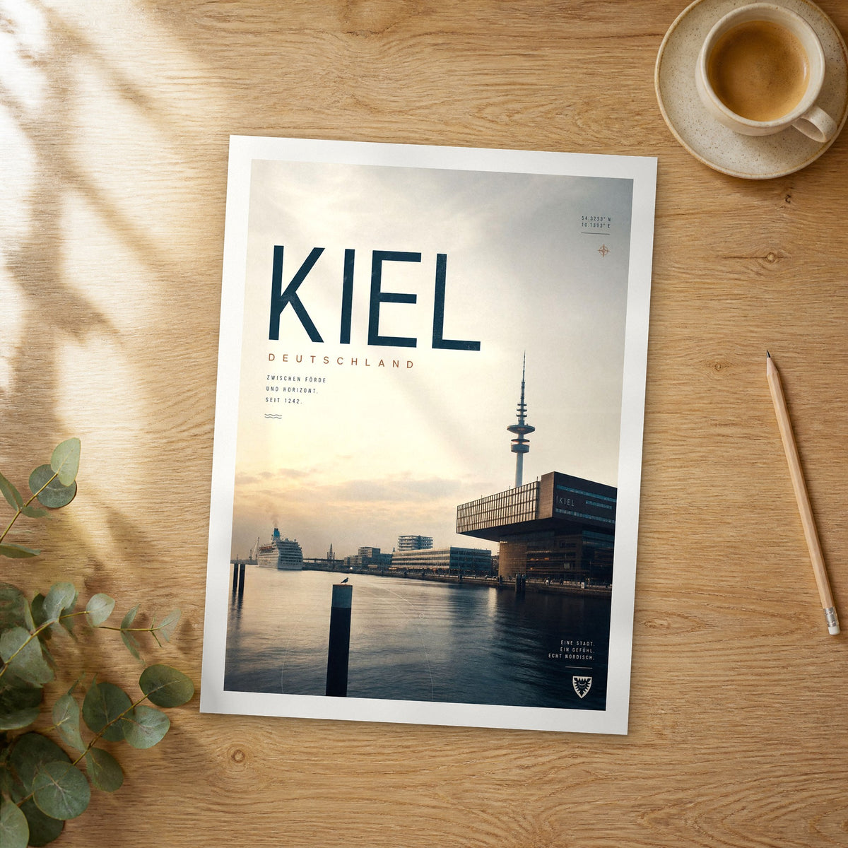 Unframed Kiel bold typography travel poster on a wooden table
