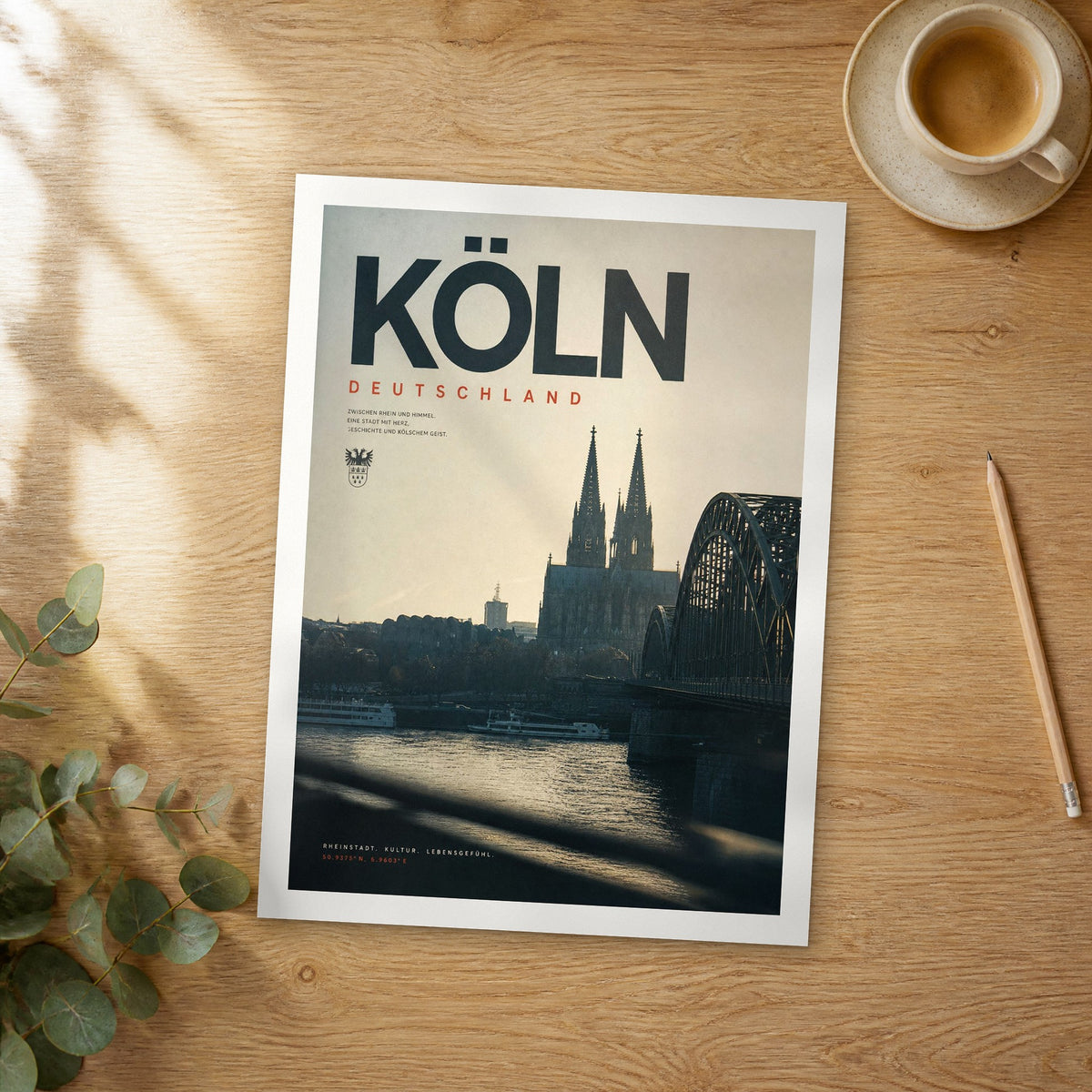 Unframed Köln bold typography travel poster on a wooden table