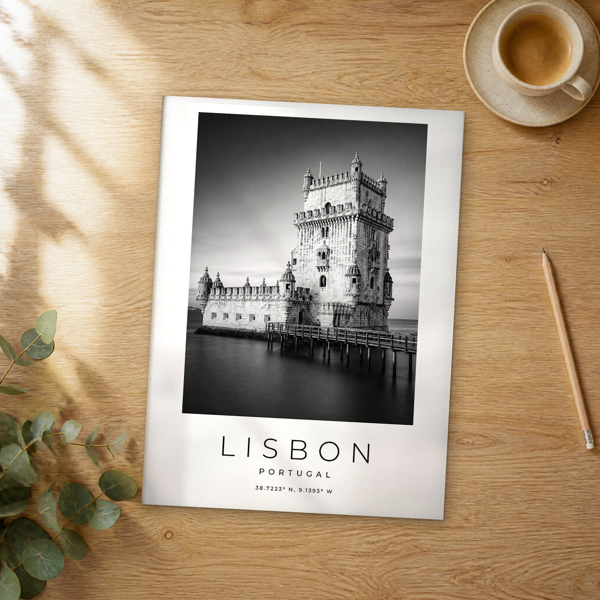 Unframed Lisbon black and white travel poster on a wooden table
