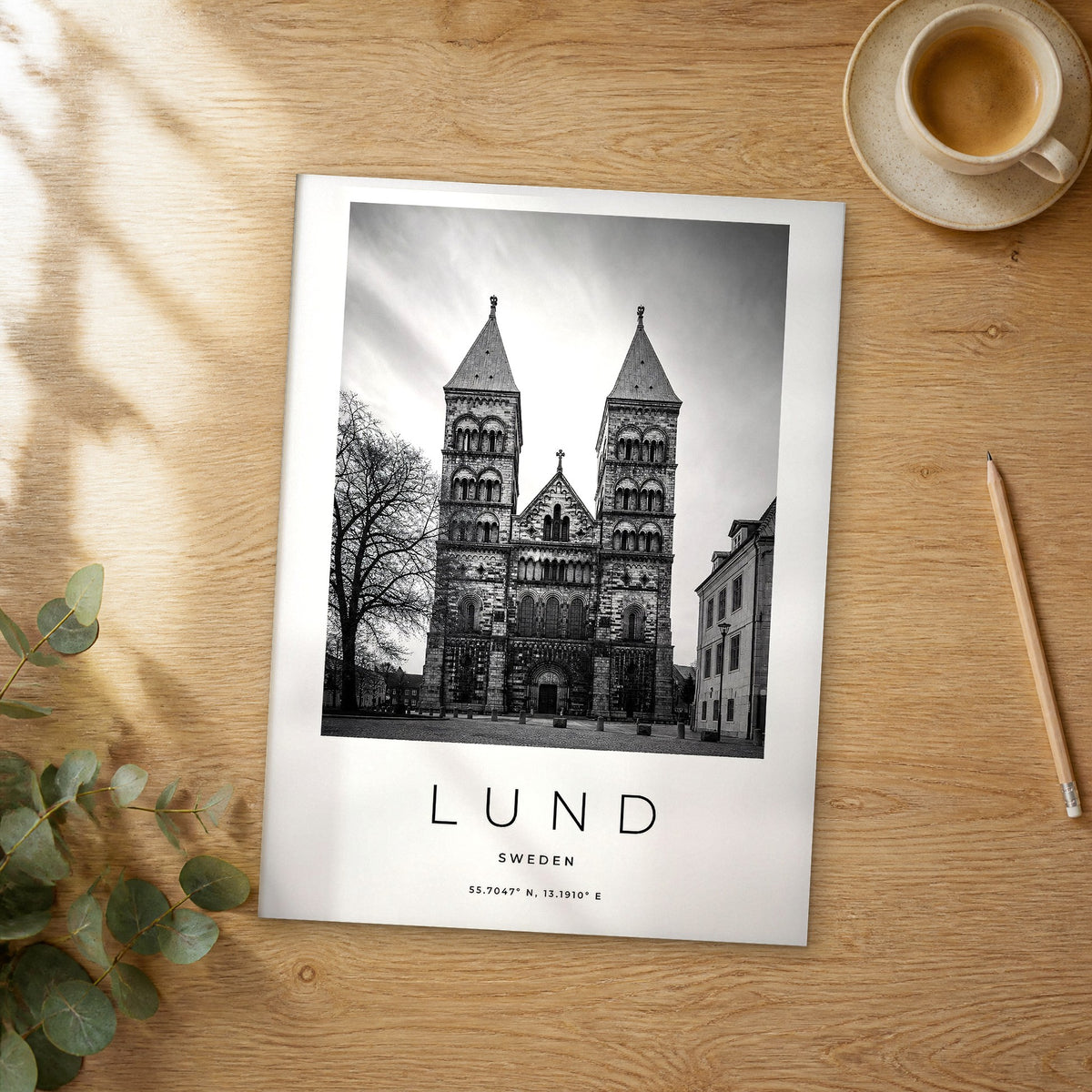 Unframed Lund black and white travel poster on a wooden table