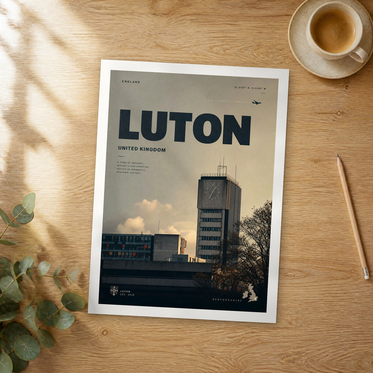 Unframed Luton bold typography travel poster on a wooden table