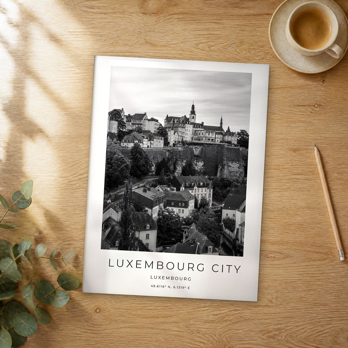 Unframed Luxembourg City black and white travel poster on a wooden table