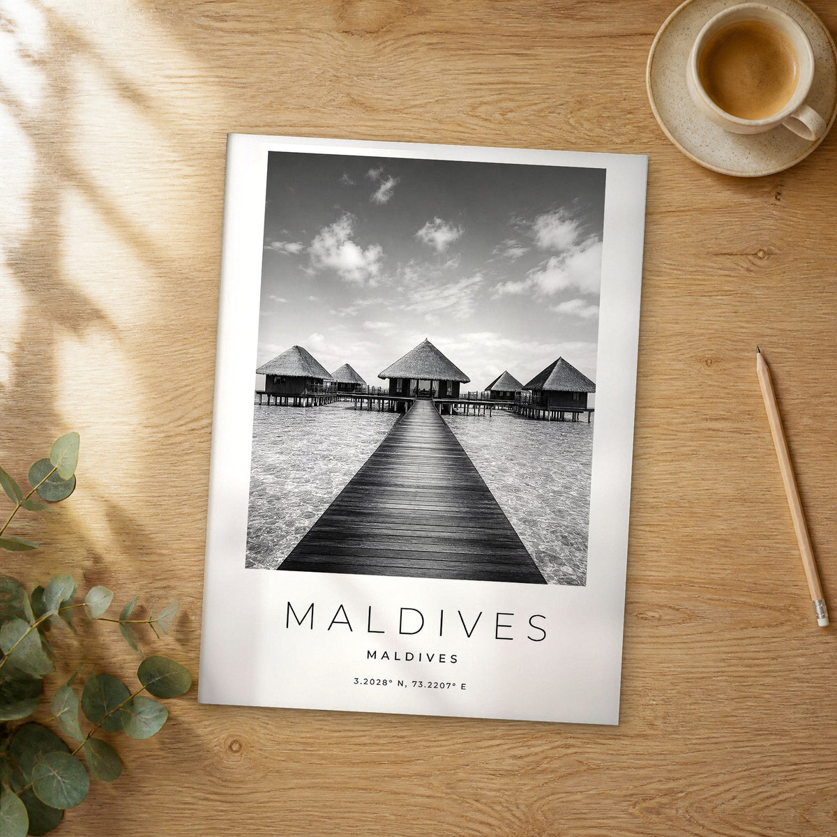 Unframed Maldives black and white travel poster on a wooden table