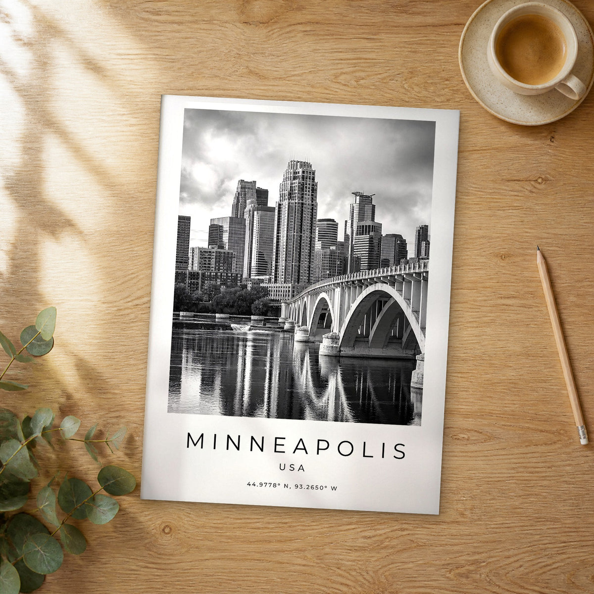 Unframed Minneapolis black and white travel poster on a wooden table