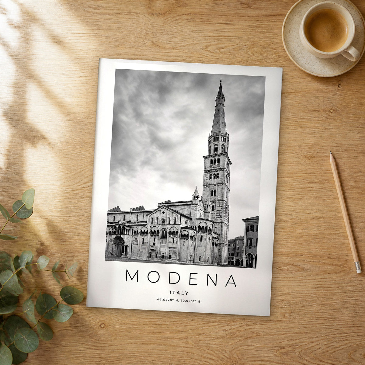 Unframed Modena black and white travel poster on a wooden table