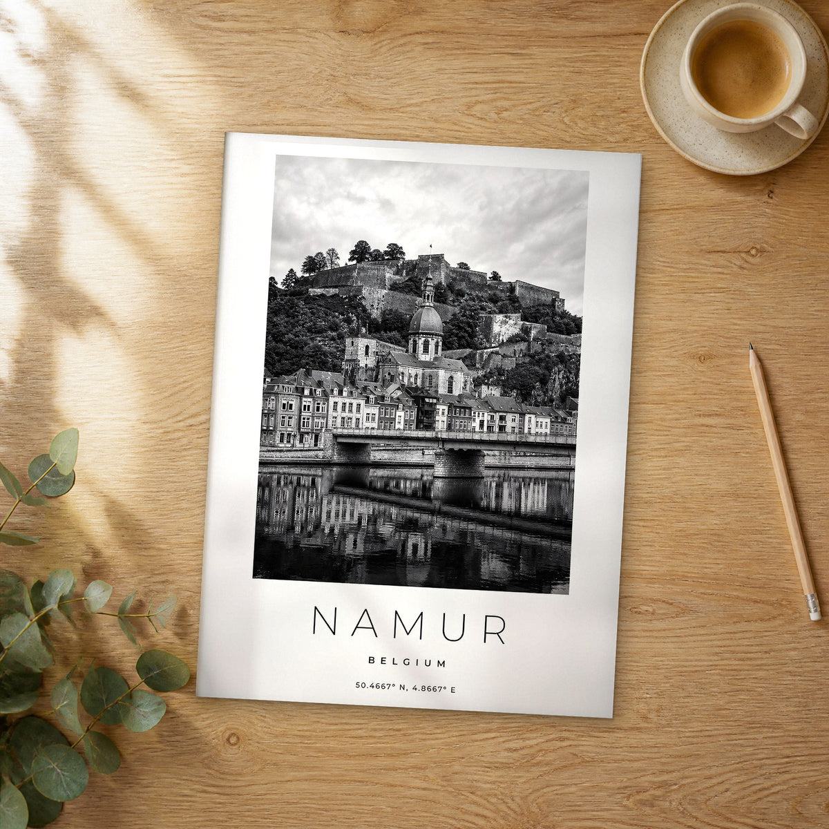 Unframed Namur black and white travel poster on a wooden table