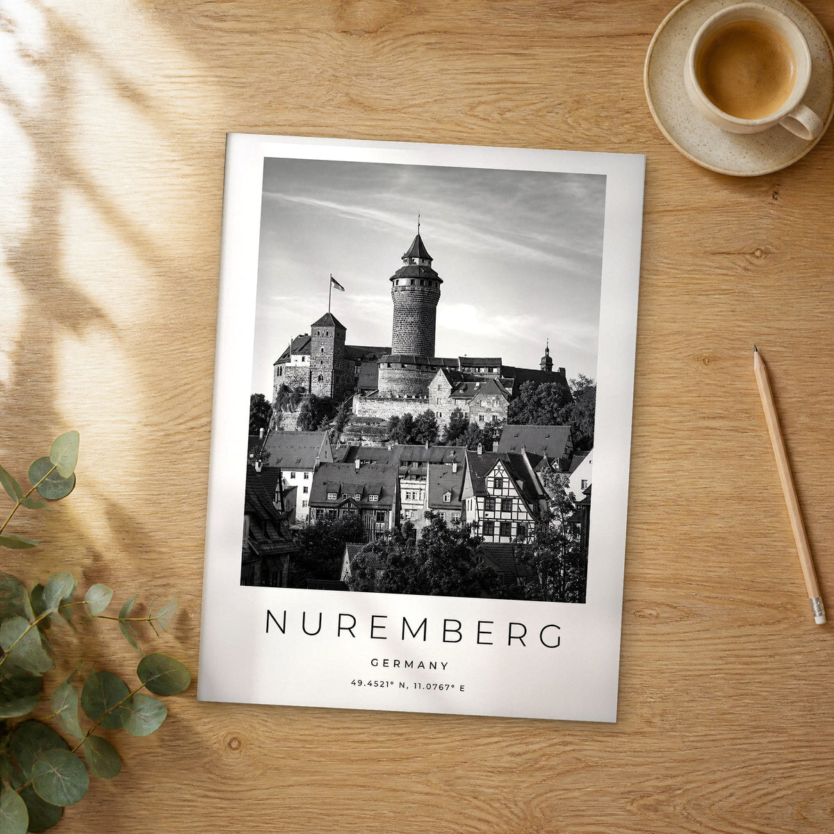 Unframed Nuremberg black and white travel poster on a wooden table
