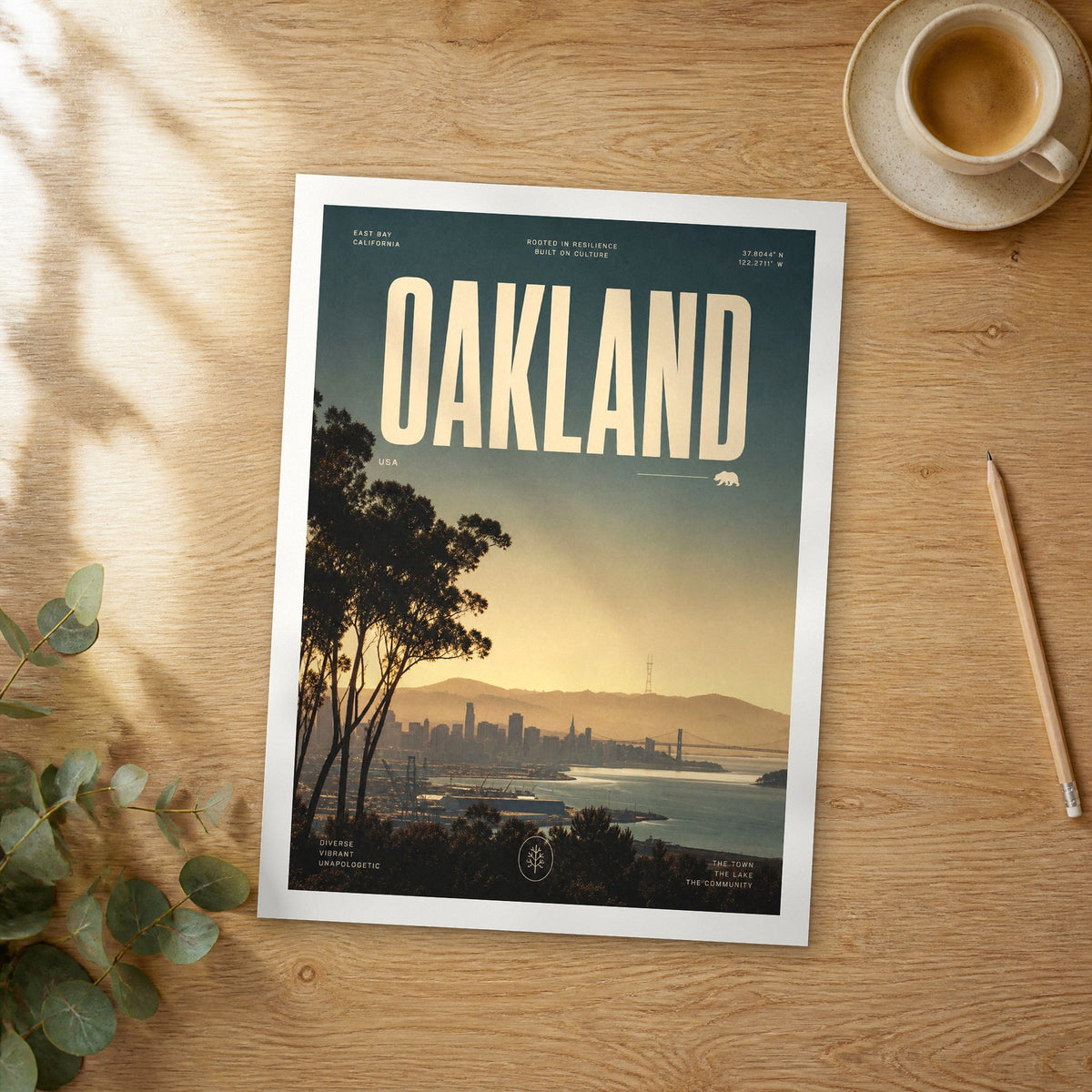 Unframed Oakland bold typography travel poster on a wooden table