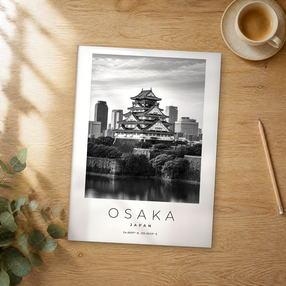 Unframed Osaka black and white travel poster on a wooden table
