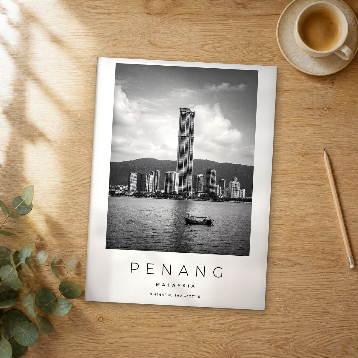 Unframed Penang black and white travel poster on a wooden table