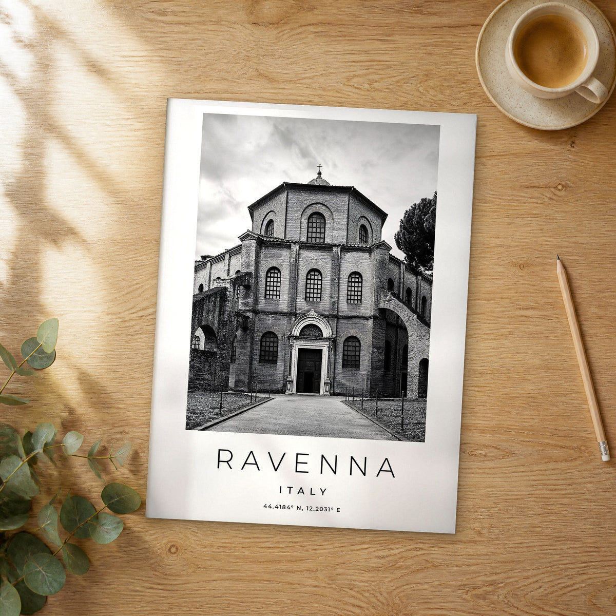 Unframed Ravenna black and white travel poster on a wooden table