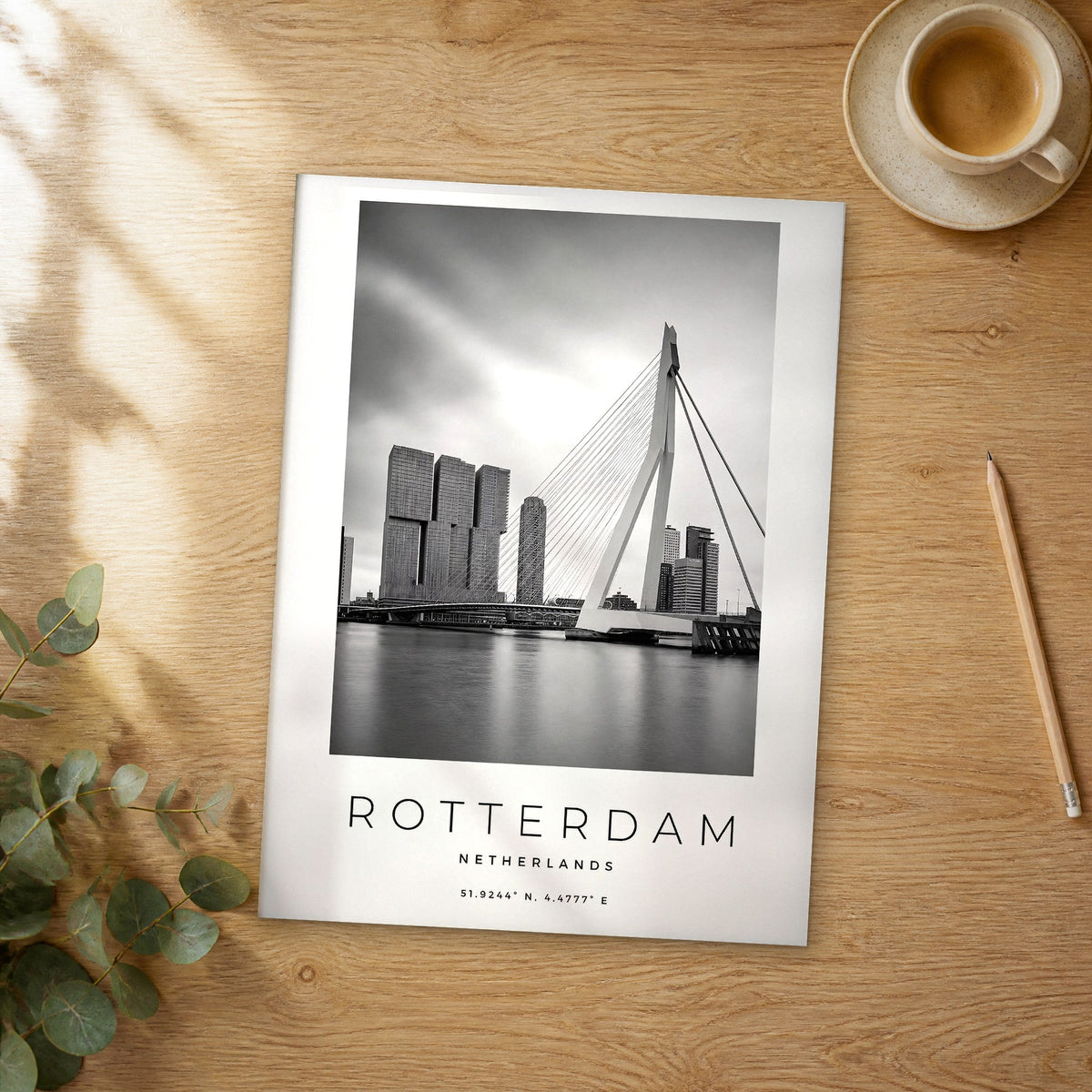 Unframed Rotterdam black and white travel poster on a wooden table