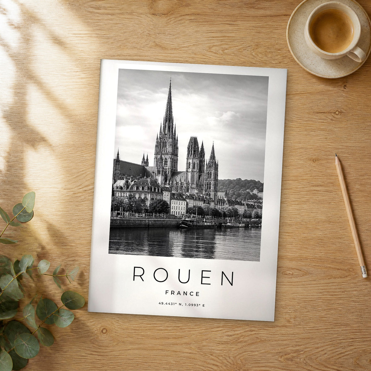 Unframed Rouen black and white travel poster on a wooden table