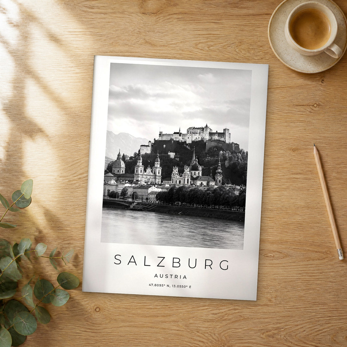 Unframed Salzburg black and white travel poster on a wooden table