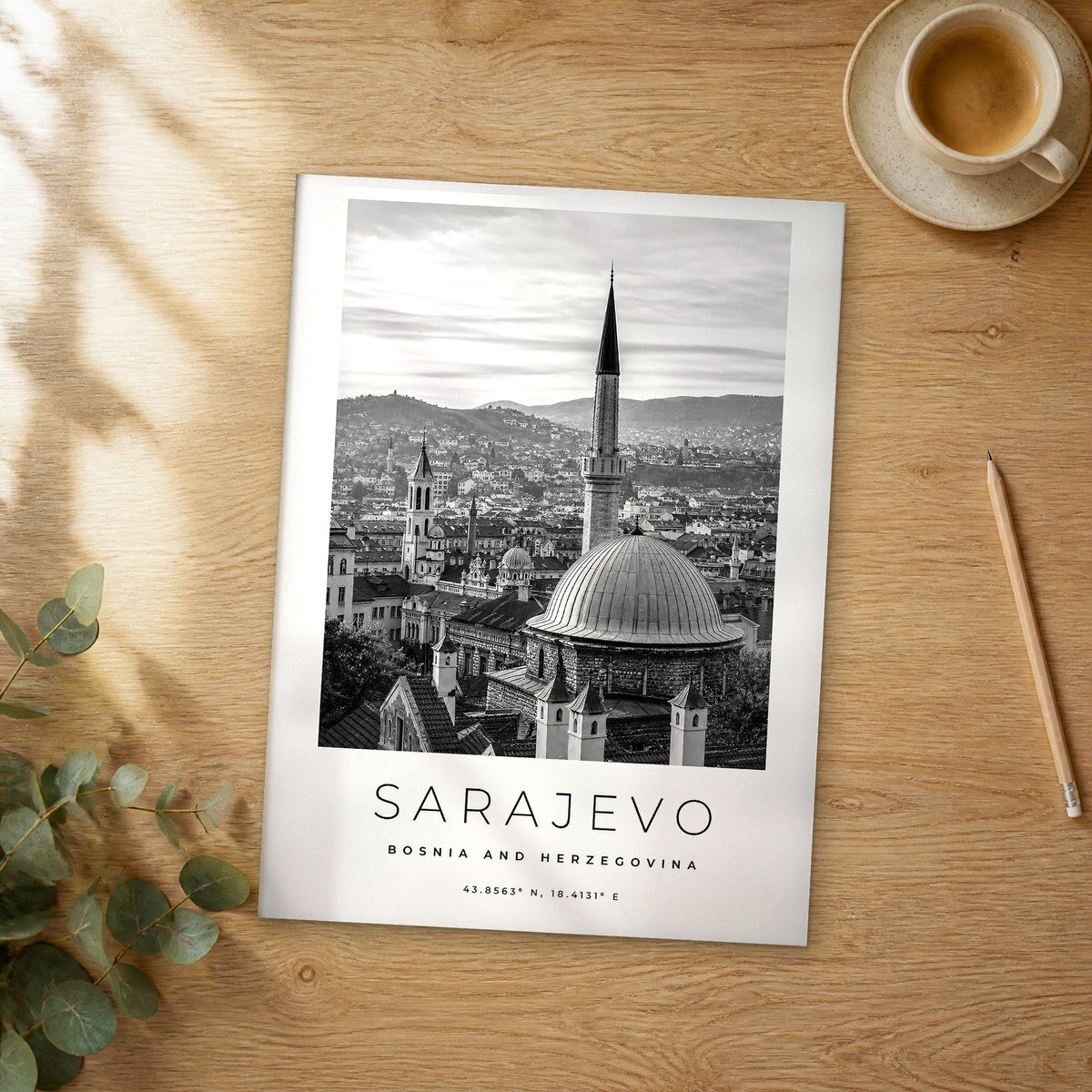 Unframed Sarajevo black and white travel poster on a wooden table