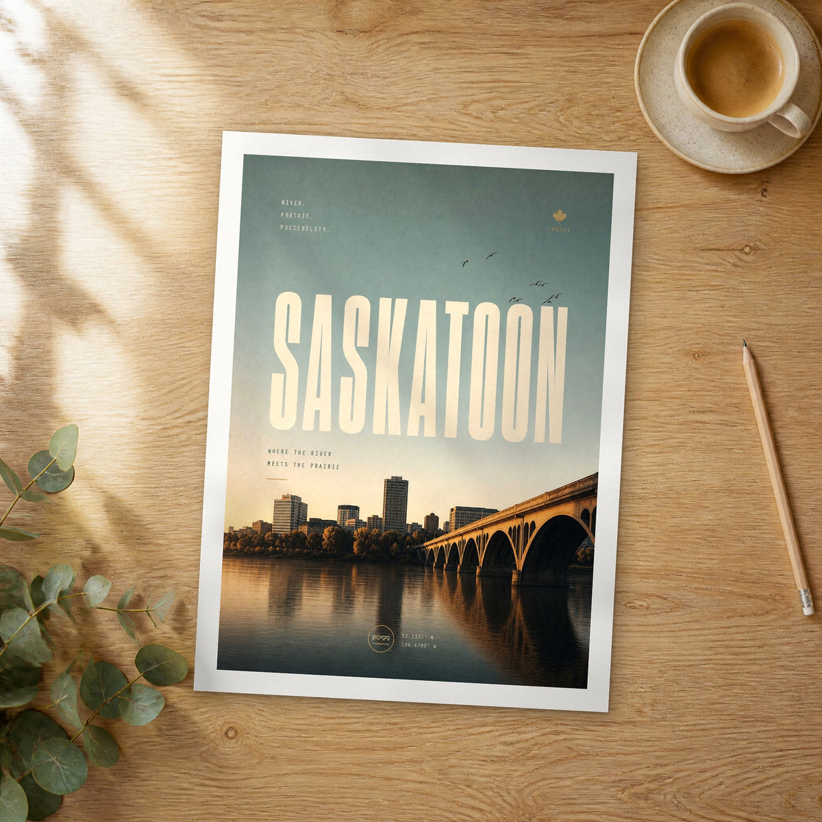 Unframed Saskatoon bold typography travel poster on a wooden table