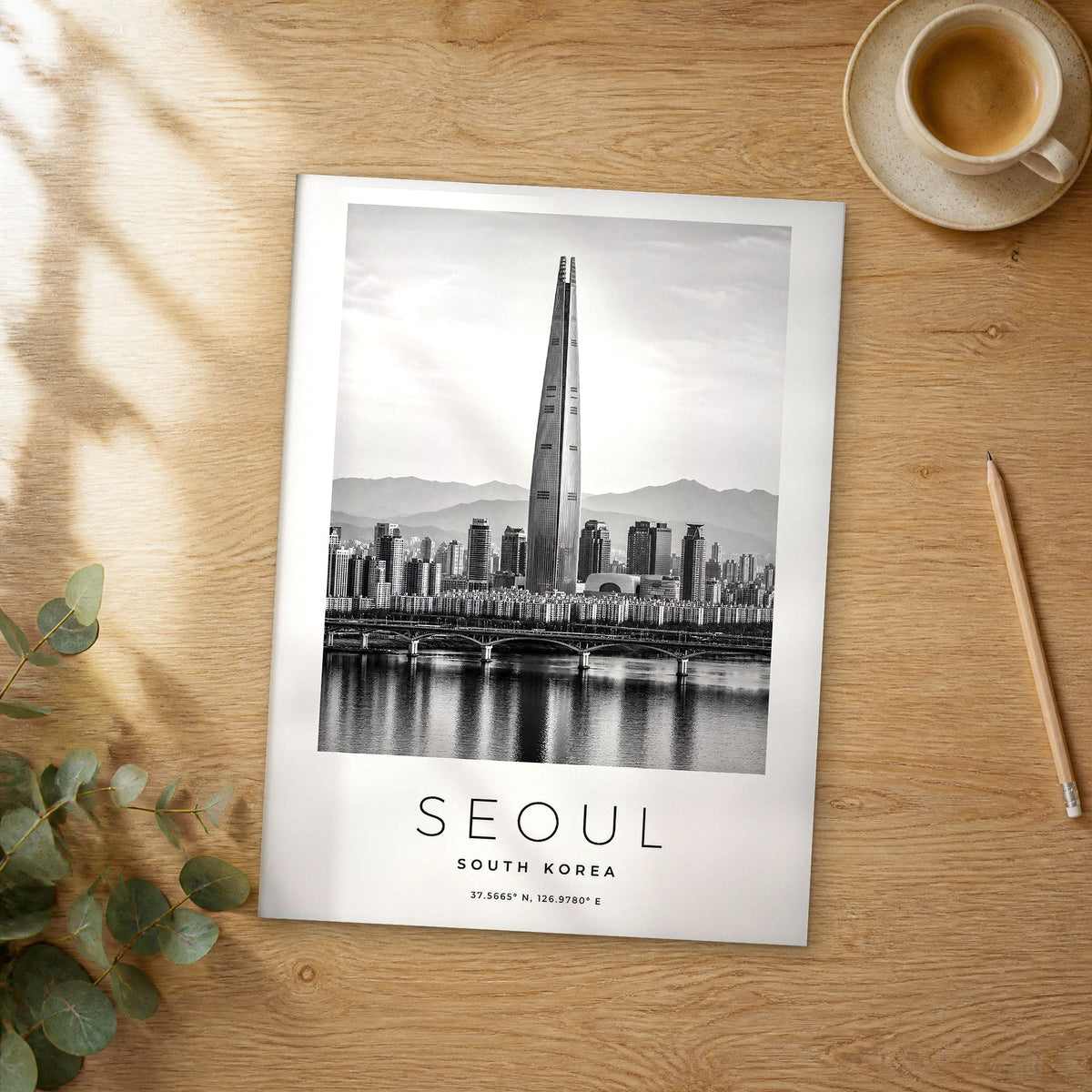 Unframed Seoul black and white travel poster on a wooden table