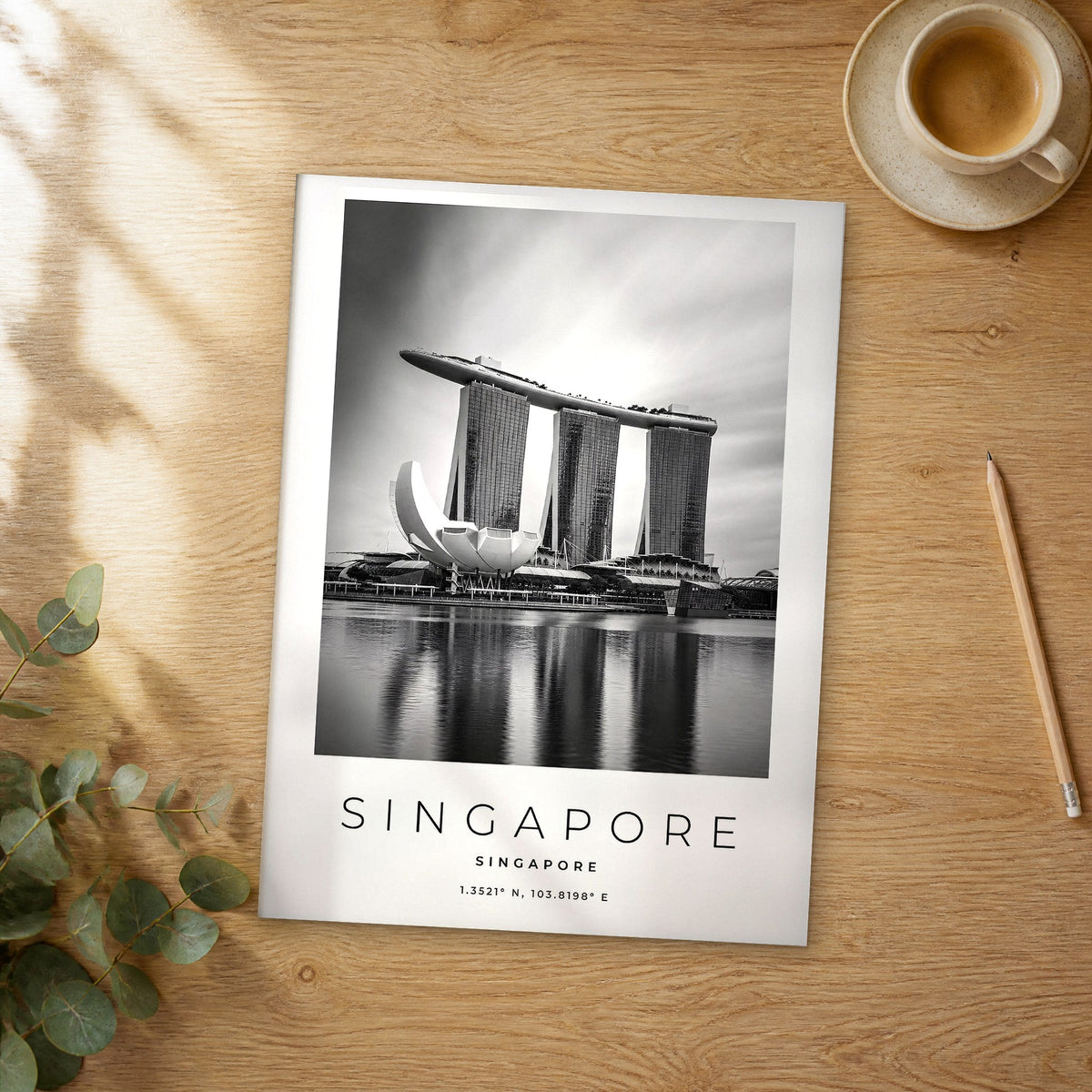 Unframed Singapore black and white travel poster on a wooden table