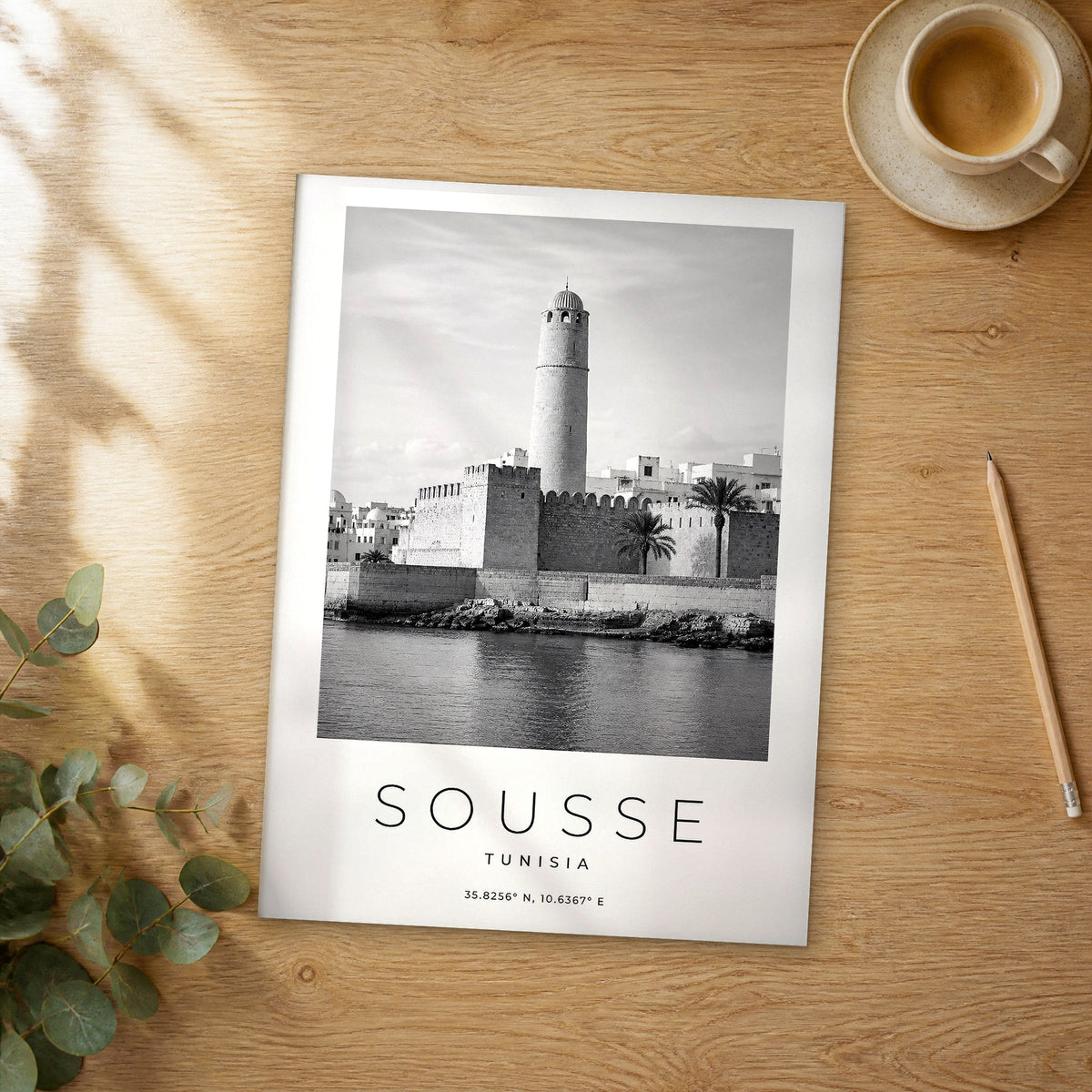 Unframed Sousse black and white travel poster on a wooden table