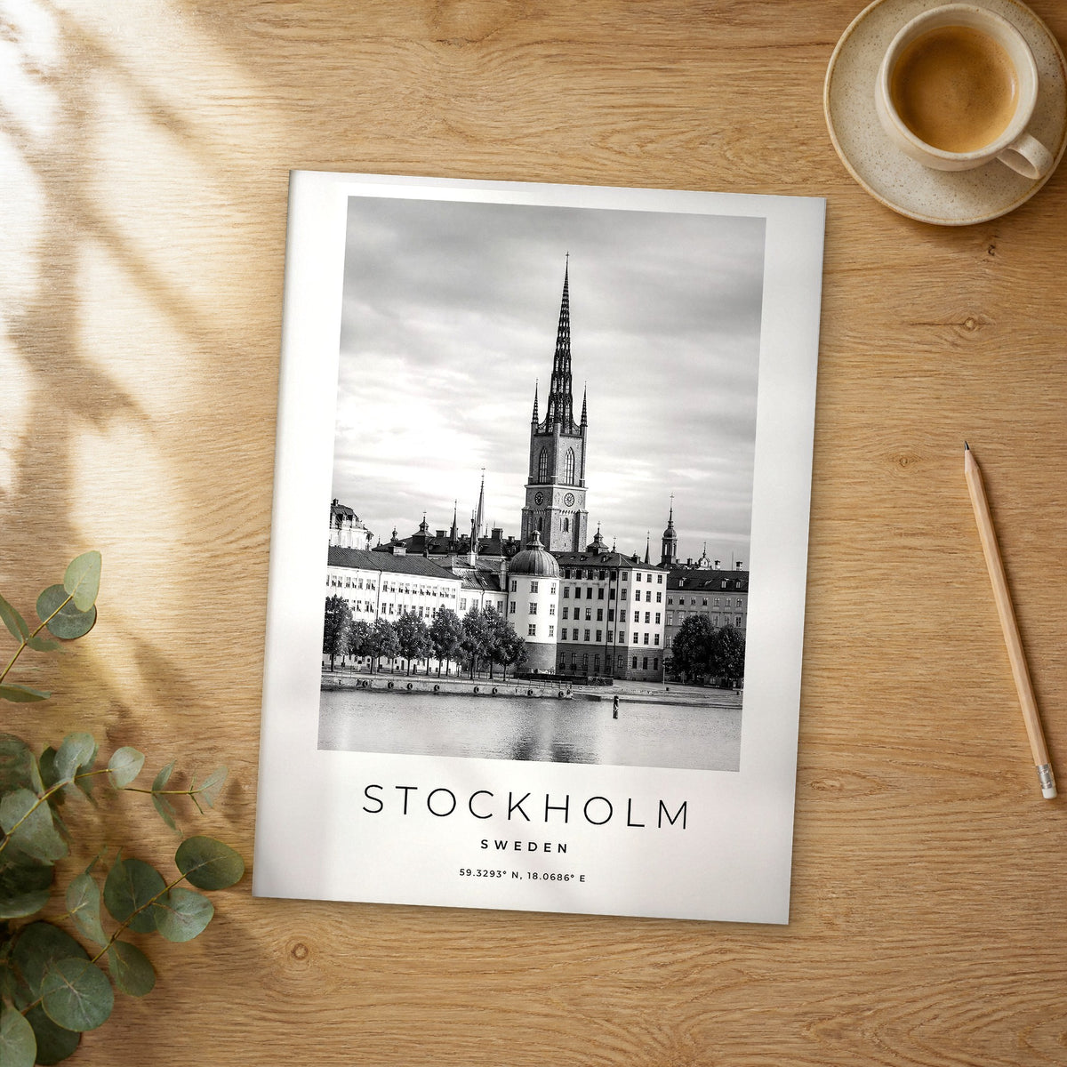 Unframed Stockholm black and white travel poster on a wooden table