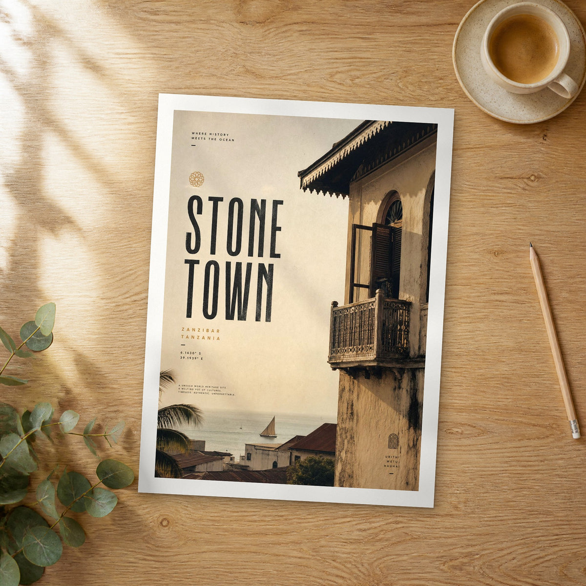 Unframed Stone Town bold typography travel poster on a wooden table