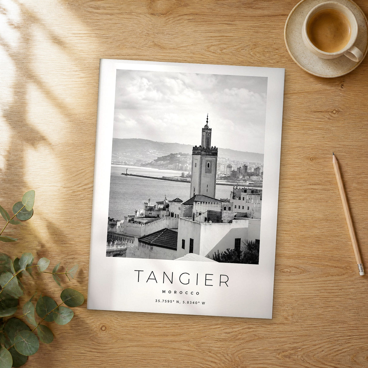 Unframed Tangier black and white travel poster on a wooden table