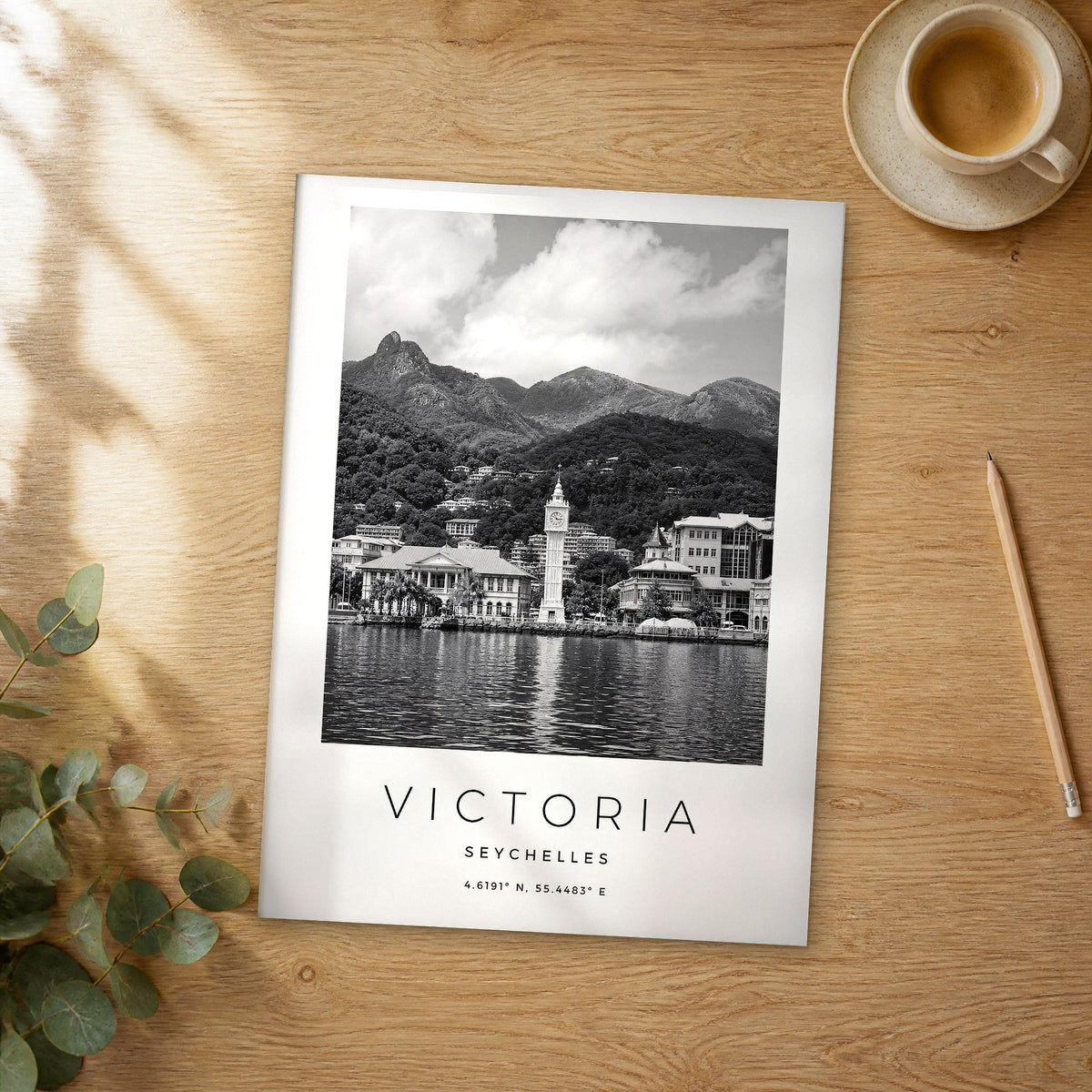 Unframed Victoria black and white travel poster on a wooden table