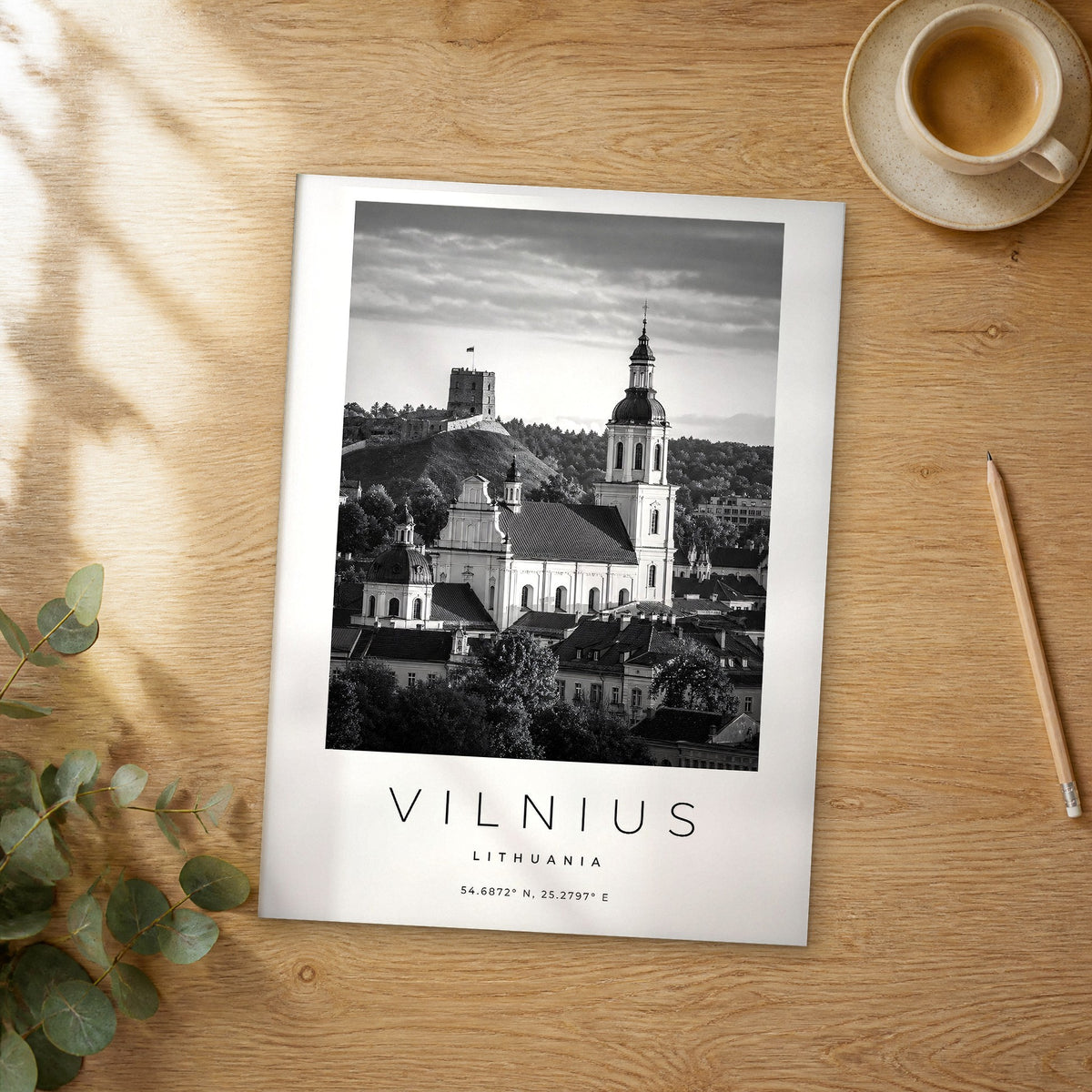 Unframed Vilnius black and white travel poster on a wooden table