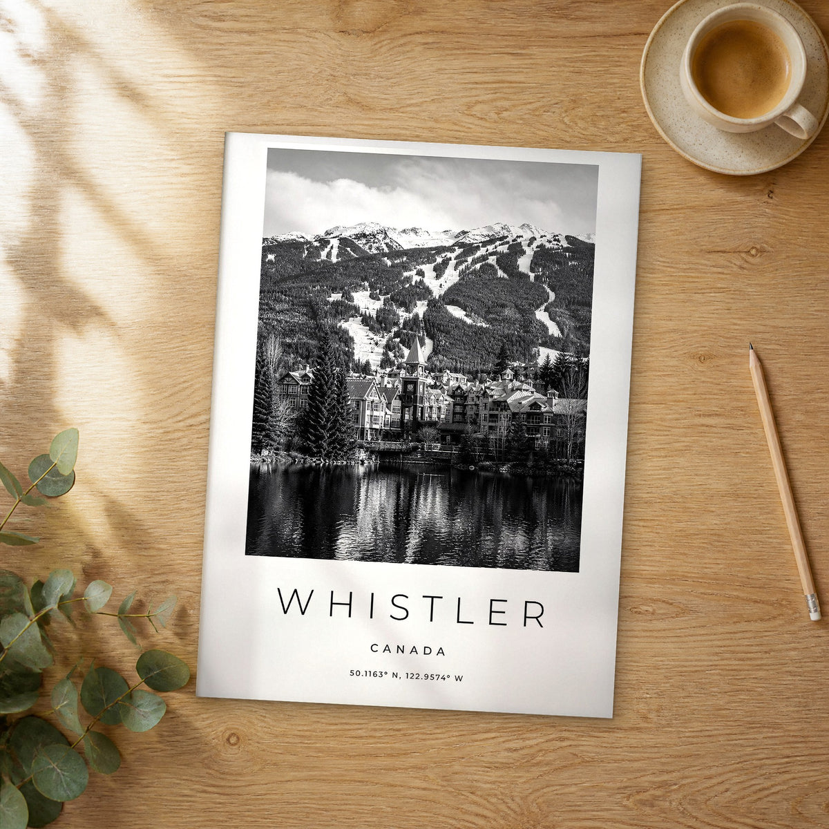 Unframed Whistler black and white travel poster on a wooden table