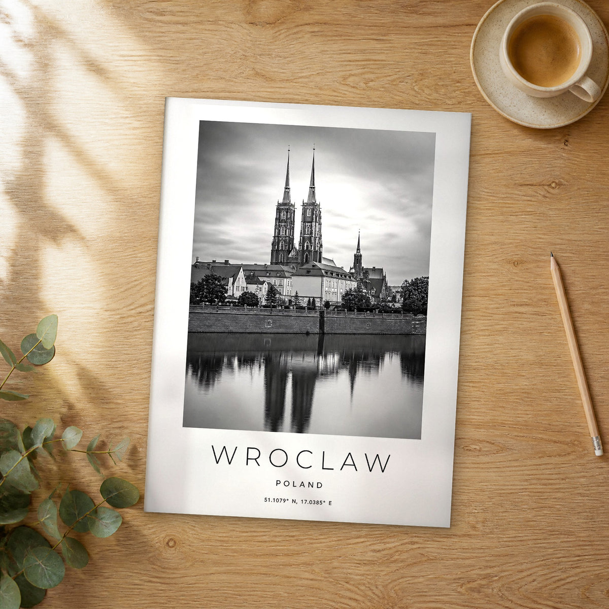 Unframed Wroclaw black and white travel poster on a wooden table